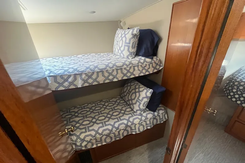 Floridita Yacht Photos Pics Bunk beds in 1997 Post Sportfish boat cabin with geometric-patterned bedding.
