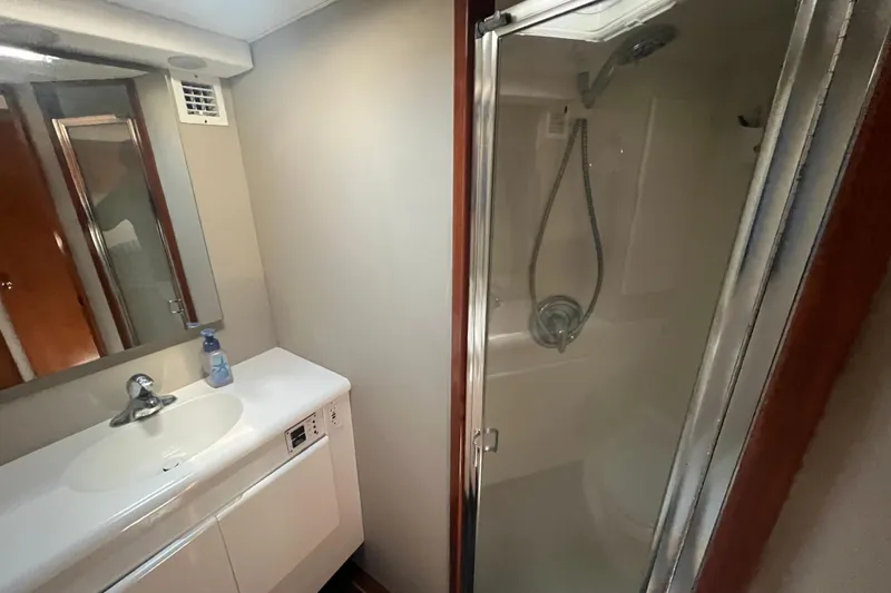 Floridita Yacht Photos Pics Bathroom interior of a 1997 Post Sportfish boat with shower and sink.