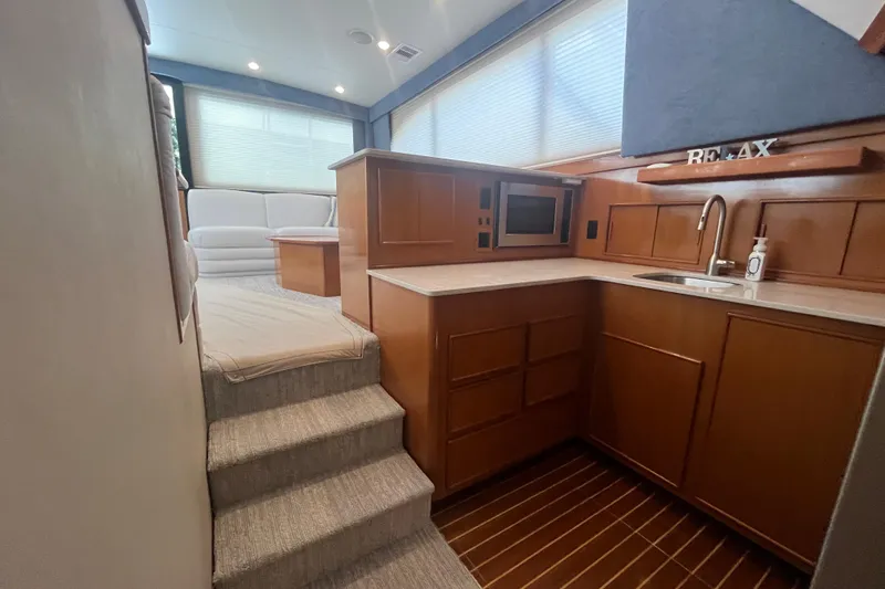 Floridita Yacht Photos Pics Luxurious 1997 Post Sportfish yacht interior with modern kitchen and cozy seating area.