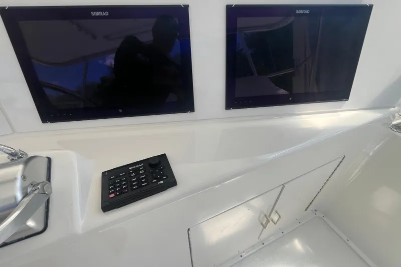 Floridita Yacht Photos Pics 1997 Post Sportfish boat dashboard with dual Simrad displays and control panel.