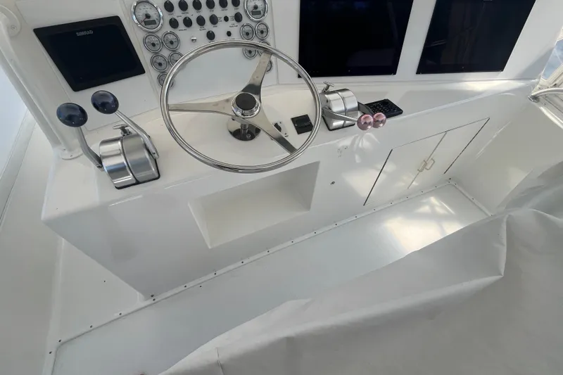 Floridita Yacht Photos Pics 1997 Post Sportfish boat helm with steering wheel, controls, and instrument panel.
