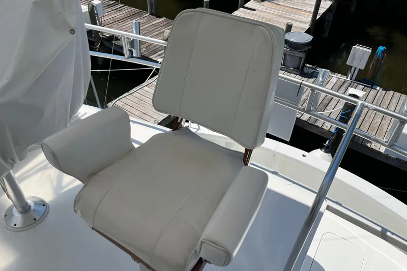 Floridita Yacht Photos Pics White captain's chair on 1997 Post Sportfish boat, dockside view.