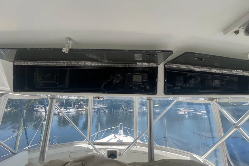 Floridita Yacht Photos Pics Interior view of 1997 Post Sportfish boat with navigation equipment and marina backdrop.