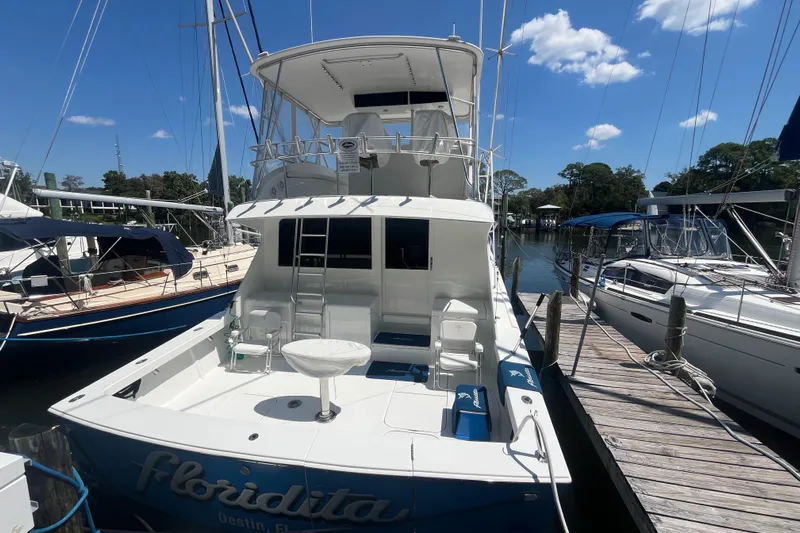 Floridita Yacht Photos Pics 1997 Post Sportfish boat docked at marina under clear blue sky.