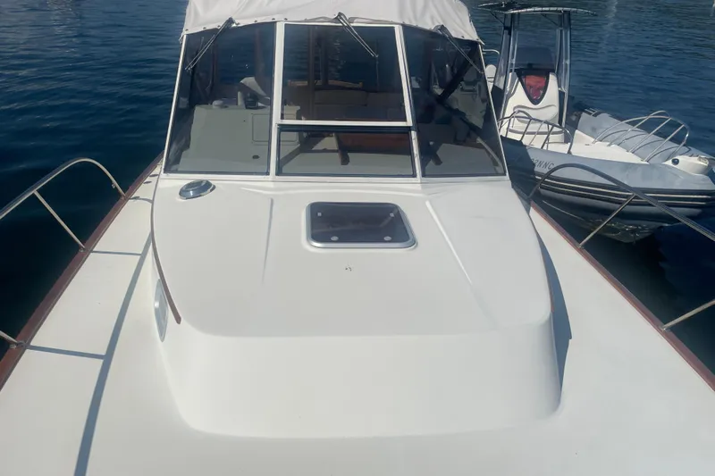 Ripple Yacht Photos Pics 1998 Little Harbor WhisperJet 36 boat docked beside another vessel on calm water.