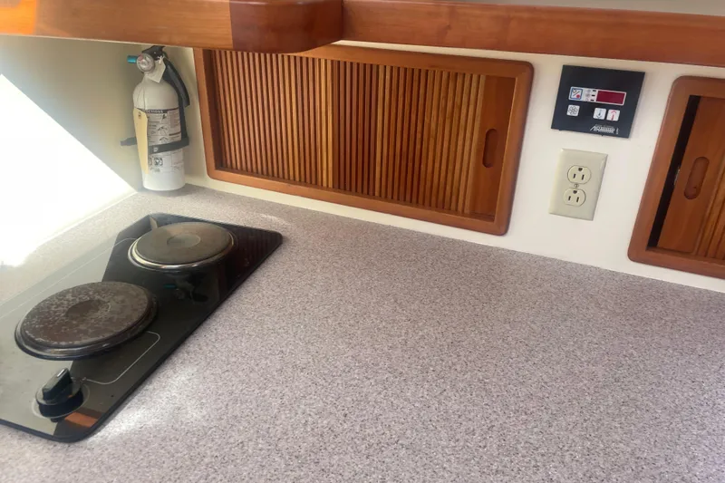 Ripple Yacht Photos Pics 1998 Little Harbor WhisperJet 36 galley with stove, fire extinguisher, and wooden cabinets.
