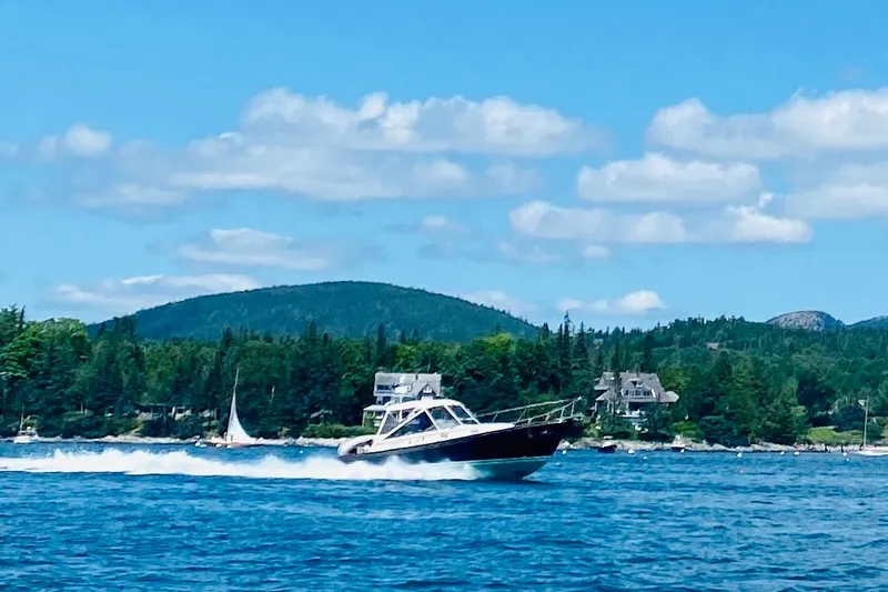 Ripple Yacht Photos Pics 1998 Little Harbor WhisperJet 36 cruising on a scenic lake with forested hills.