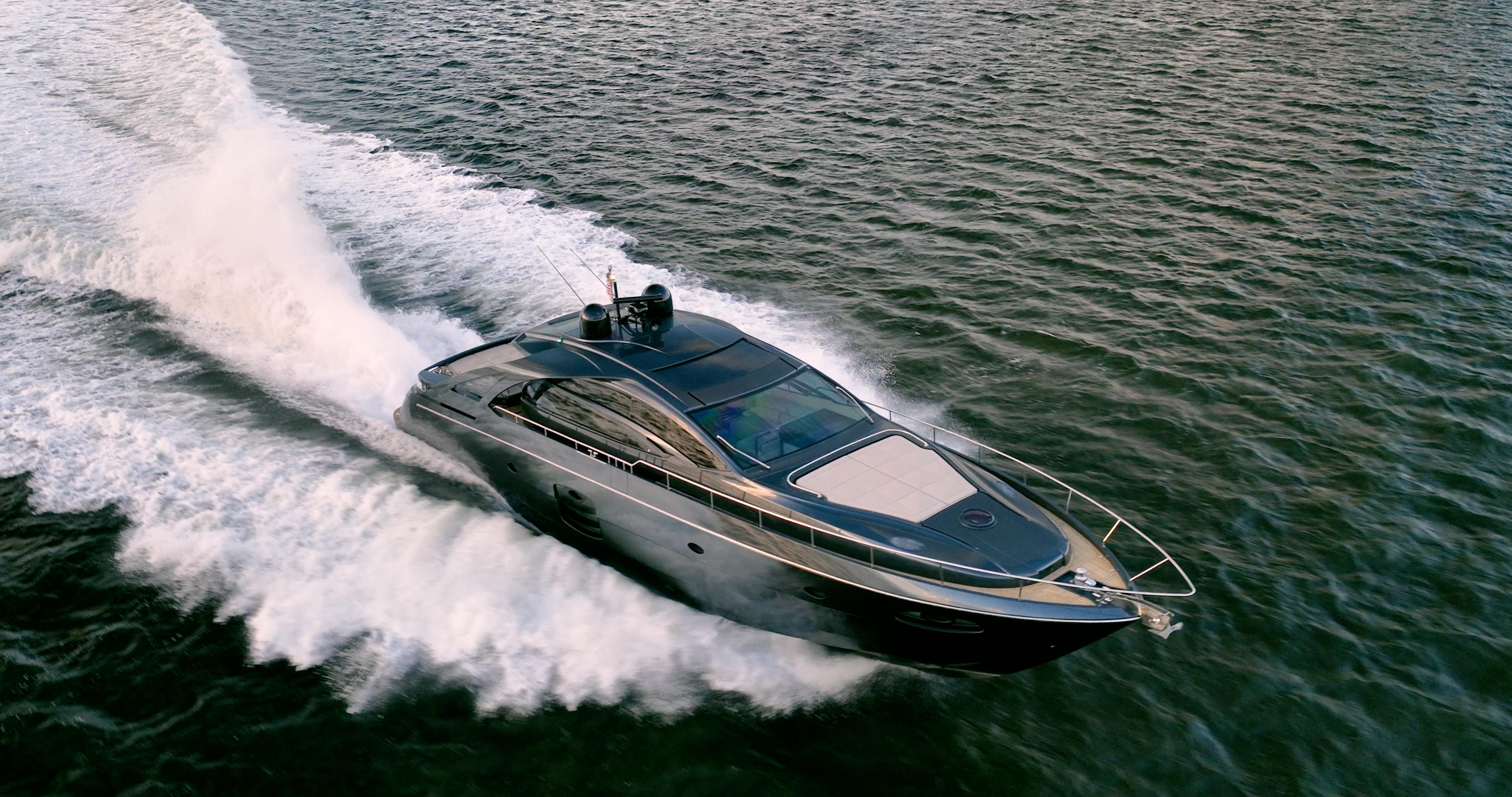 Luxury 2017 Pershing 70 yacht cruising swiftly on open water.