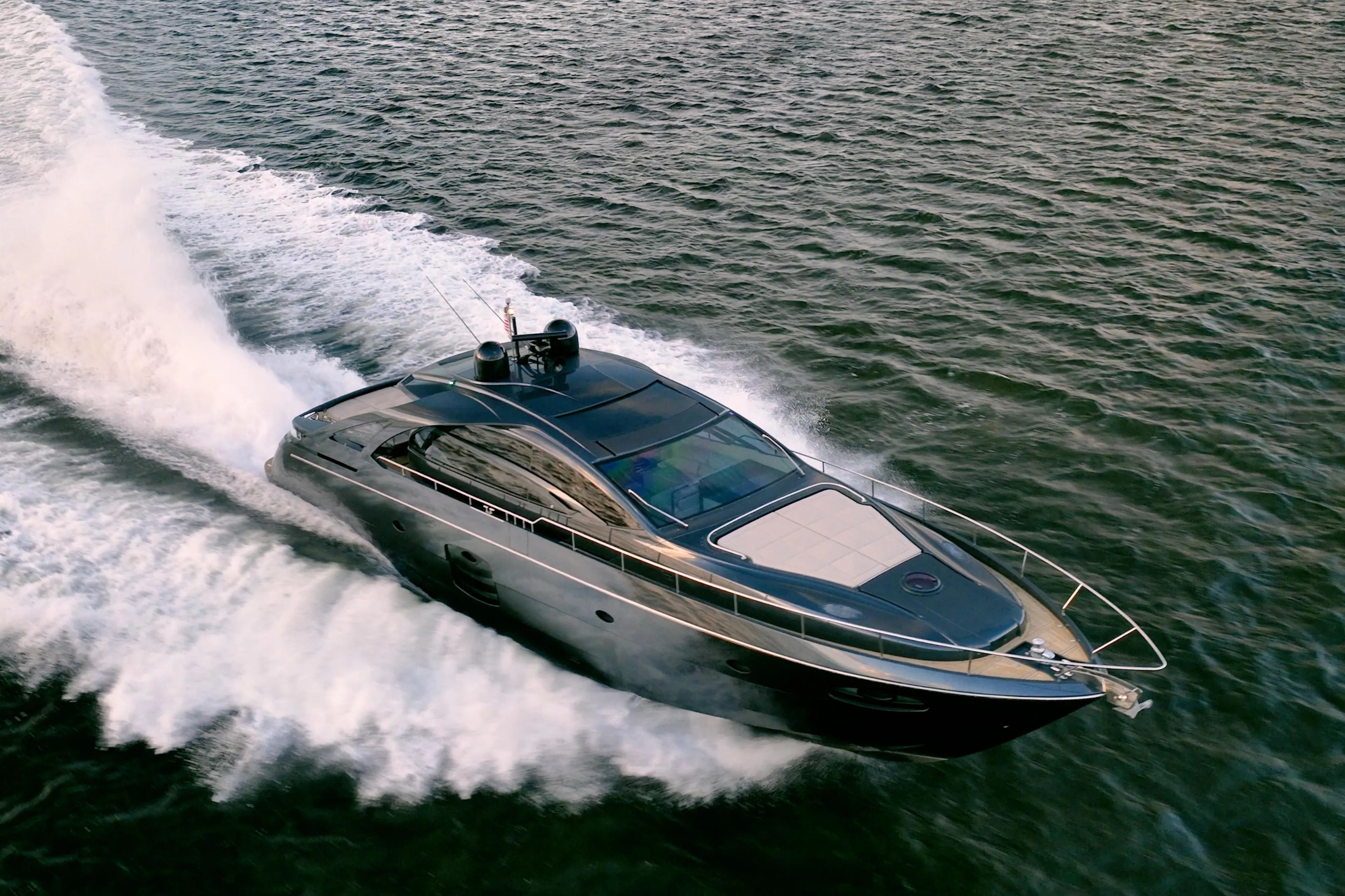 Luxury 2017 Pershing 70 yacht cruising swiftly on open water.