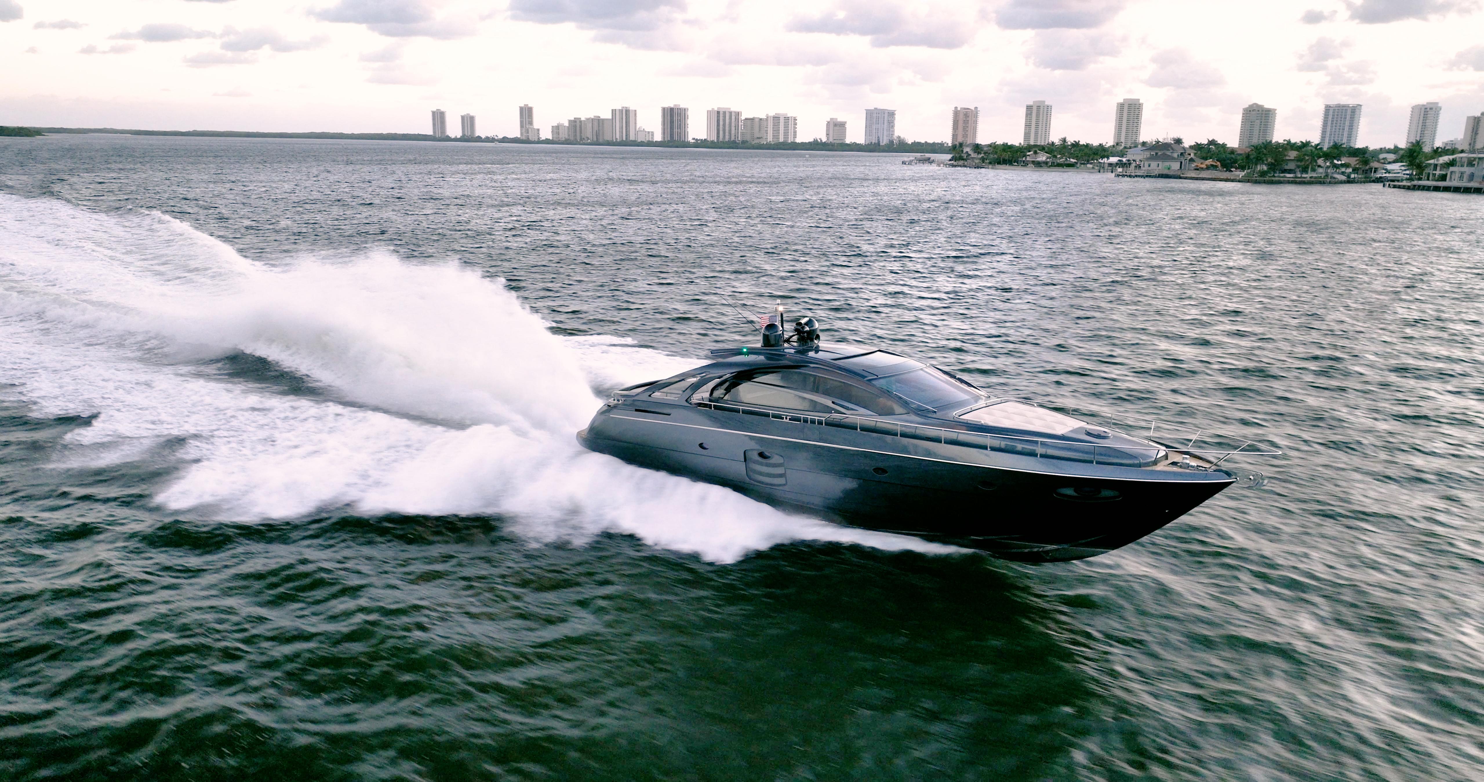 Luxurious 2017 Pershing 70 yacht cruising swiftly on open water.