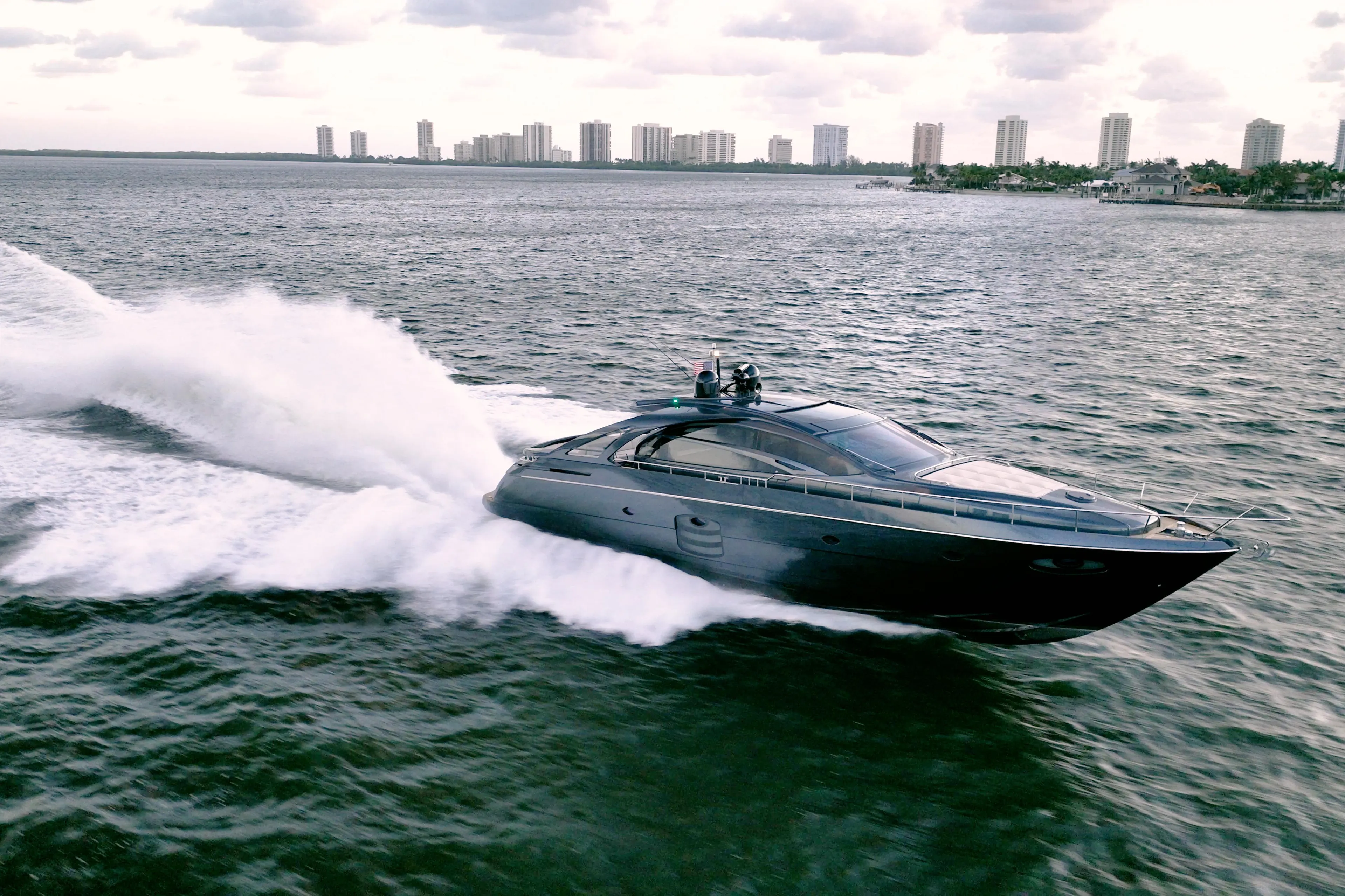 Luxurious 2017 Pershing 70 yacht cruising swiftly on open water.