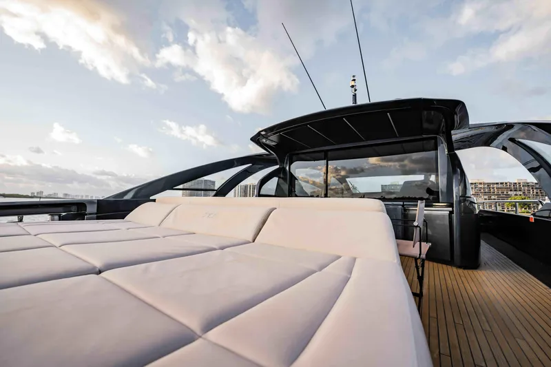  Yacht Photos Pics Luxurious 2017 Pershing 70 yacht with sleek design and spacious deck under a cloudy sky.