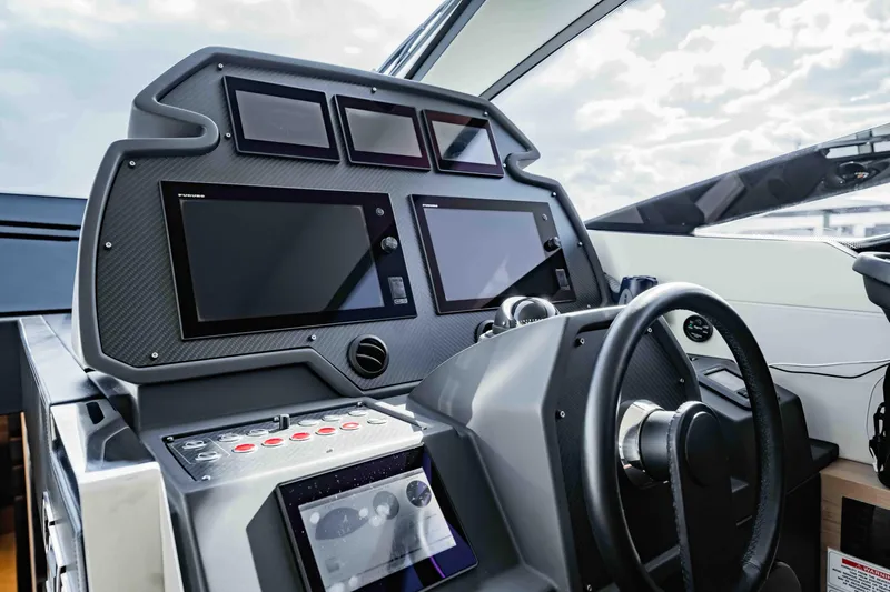  Yacht Photos Pics Cockpit of 2017 Pershing 70 yacht with advanced navigation displays and steering wheel.