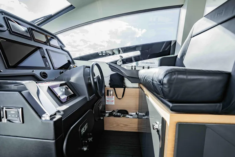  Yacht Photos Pics Interior cockpit of 2017 Pershing 70 yacht with modern controls and leather seating.