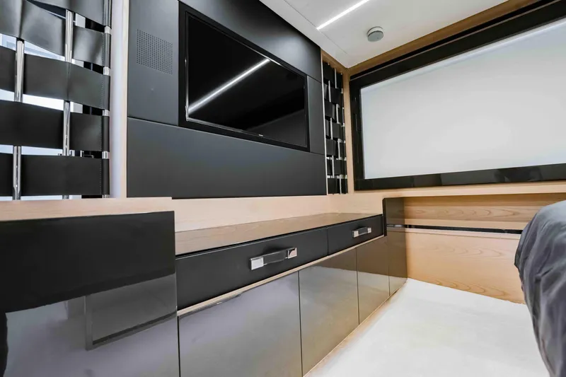  Yacht Photos Pics Luxurious interior of 2017 Pershing 70 yacht with sleek black cabinetry and modern TV setup.