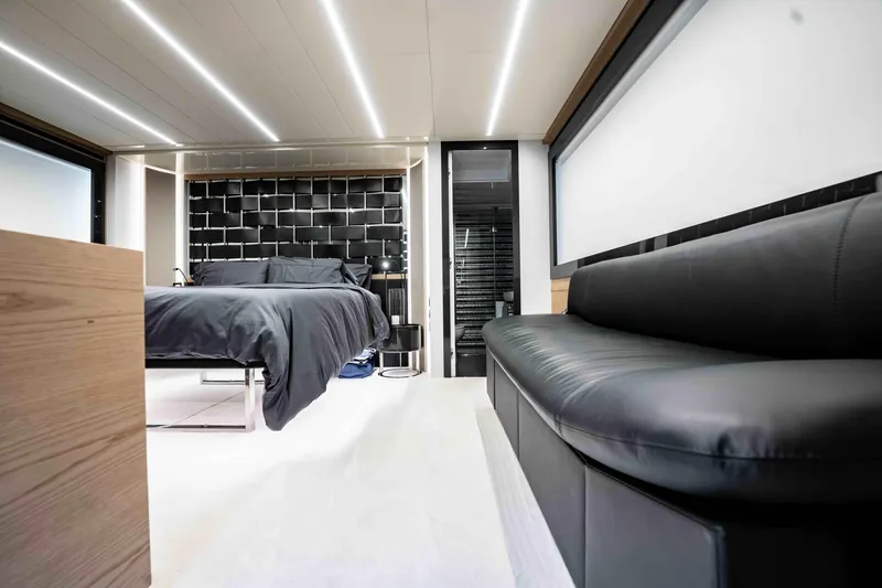  Yacht Photos Pics Luxurious interior of 2017 Pershing 70 yacht with modern bedroom and sleek black sofa.