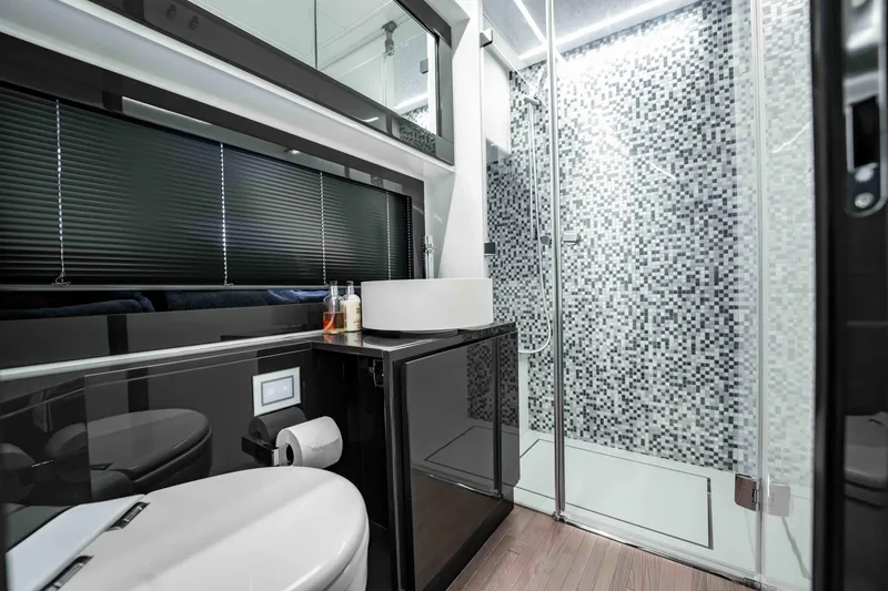  Yacht Photos Pics Luxurious bathroom in 2017 Pershing 70 yacht with modern fixtures and mosaic-tiled shower.