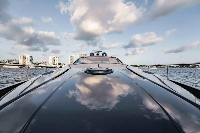  Yacht Photos Pics 2017 Pershing 70 yacht reflecting clouds, cruising near city skyline.