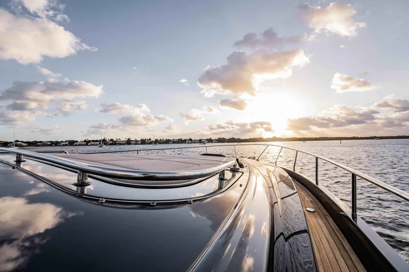  Yacht Photos Pics Luxurious 2017 Pershing 70 yacht cruising at sunset on calm waters.