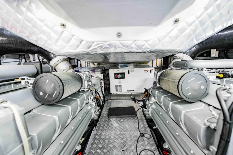  Yacht Photos Pics Engine room of a 2017 Pershing 70 yacht, featuring dual engines and a Kohler generator.