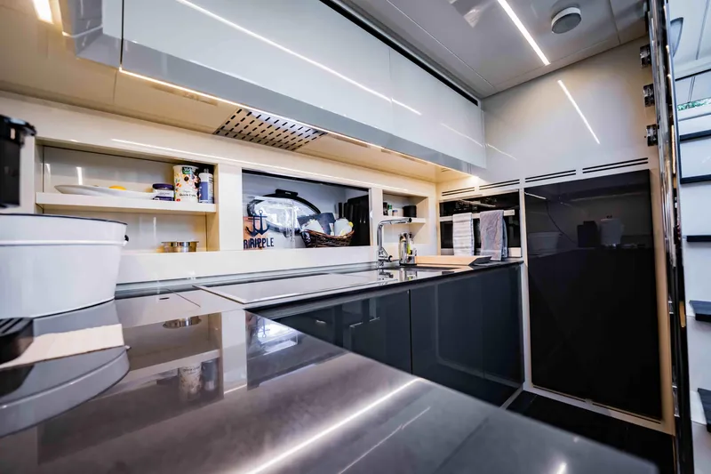  Yacht Photos Pics Modern kitchen interior on a 2017 Pershing 70 yacht, featuring sleek cabinetry and appliances.