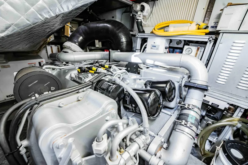  Yacht Photos Pics Engine room of a 2017 Pershing 70 yacht, showcasing complex machinery and components.