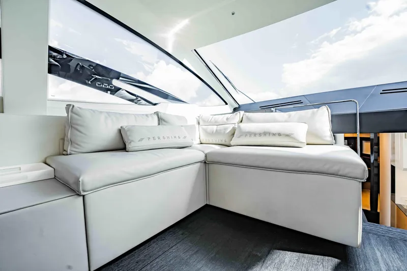  Yacht Photos Pics Luxurious interior of 2017 Pershing 70 yacht with plush white seating and cushions.