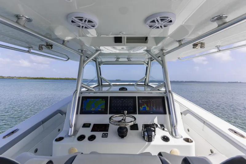  Yacht Photos Pics 2018 Yellowfin 42 Offshore boat cockpit with navigation screens and ocean view.