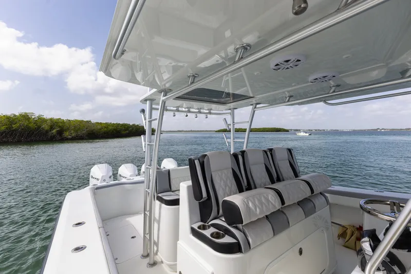  Yacht Photos Pics 2018 Yellowfin 42 Offshore boat interior with seating, on a calm waterway.