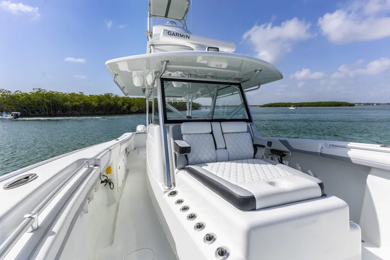  Yacht Photos Pics 2018 Yellowfin 42 Offshore boat on water, featuring sleek design and comfortable seating.