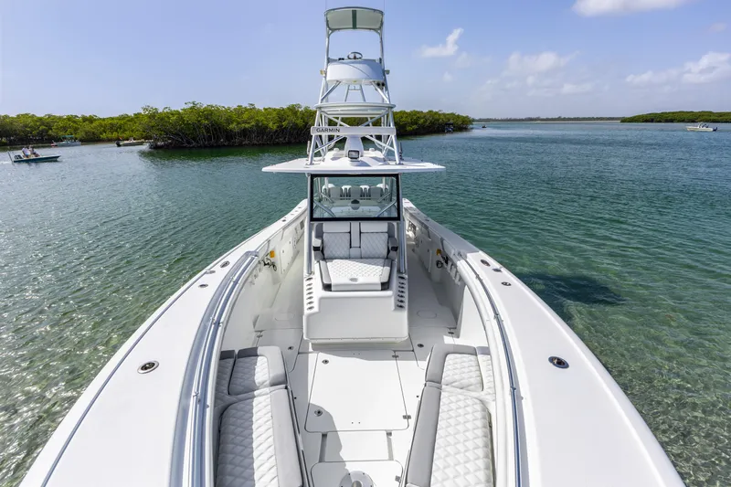  Yacht Photos Pics 2018 Yellowfin 42 Offshore boat on clear water, featuring spacious deck and seating.