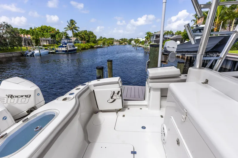  Yacht Photos Pics 2018 Yellowfin 42 Offshore boat docked on a scenic waterway with lush greenery.
