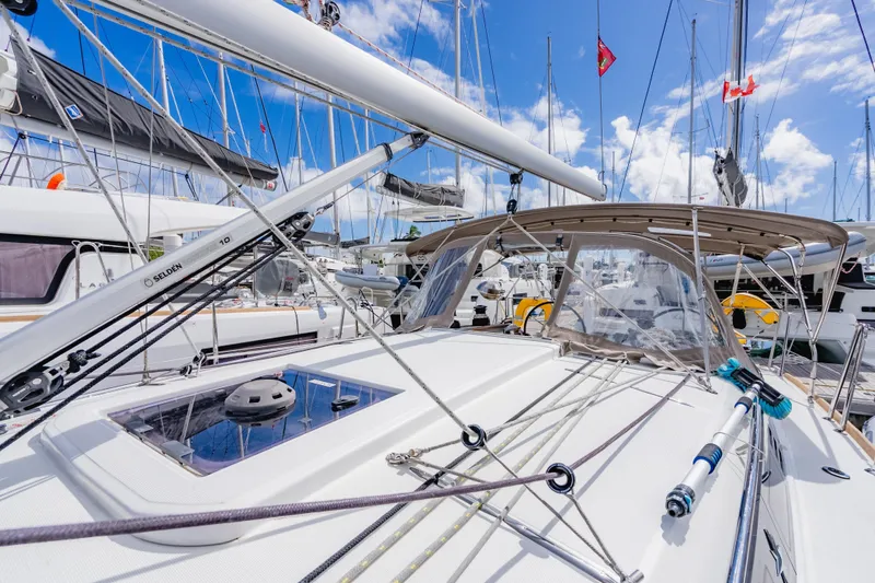 Minx Yacht Photos Pics 2024 Jeanneau Sun Odyssey 349 sailboat deck with rigging and canopy under blue sky.
