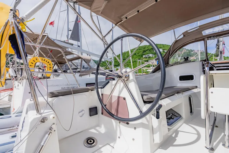 Minx Yacht Photos Pics 2024 Jeanneau Sun Odyssey 349 yacht cockpit with steering wheel, docked in marina.
