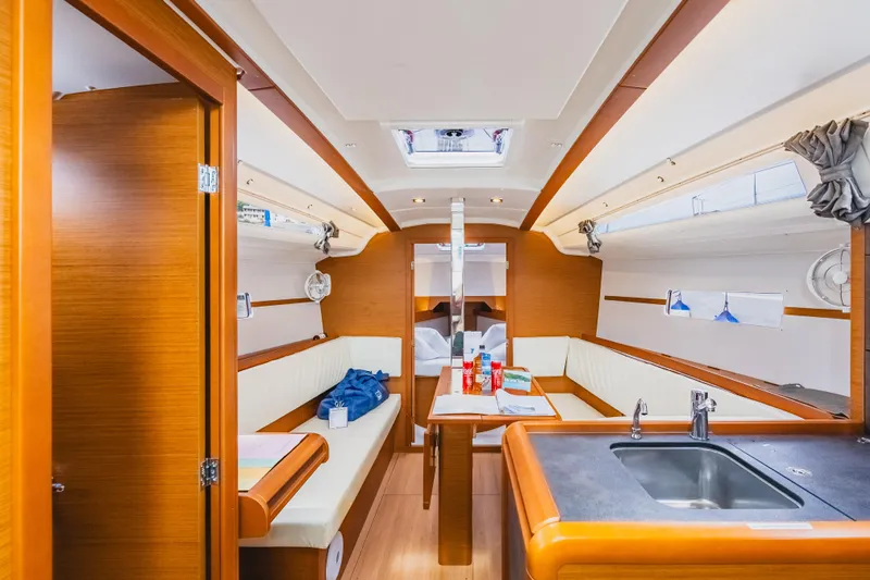 Minx Yacht Photos Pics Interior of 2024 Jeanneau Sun Odyssey 349 sailboat, featuring modern wood finish and cozy seating.
