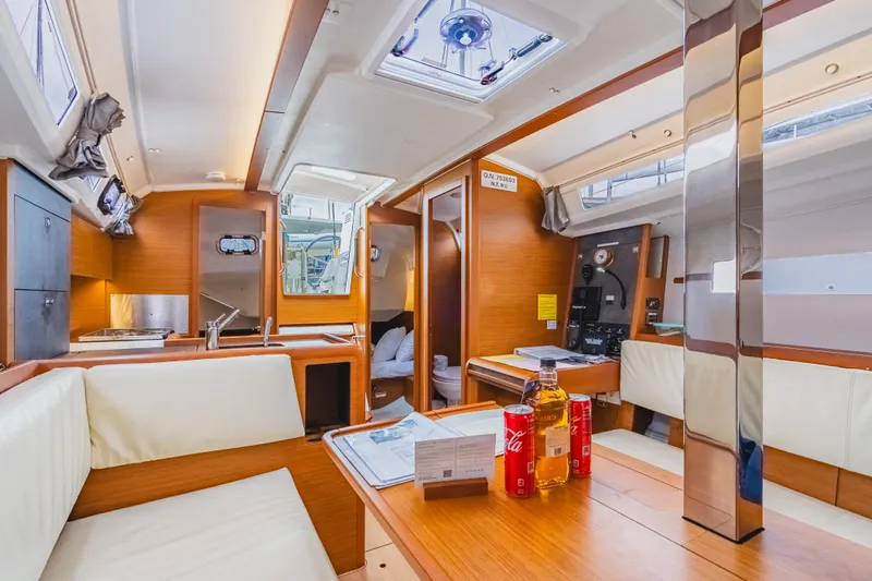 Minx Yacht Photos Pics 2024 Jeanneau Sun Odyssey 349 yacht interior with modern kitchen and cozy seating area.