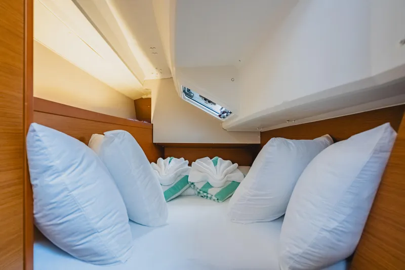 Minx Yacht Photos Pics Cozy cabin interior of 2024 Jeanneau Sun Odyssey 349 with plush pillows and elegant decor.