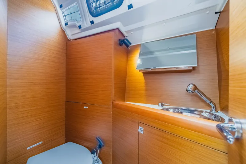 Minx Yacht Photos Pics 2024 Jeanneau Sun Odyssey 349 yacht bathroom with wooden finish and modern fixtures.