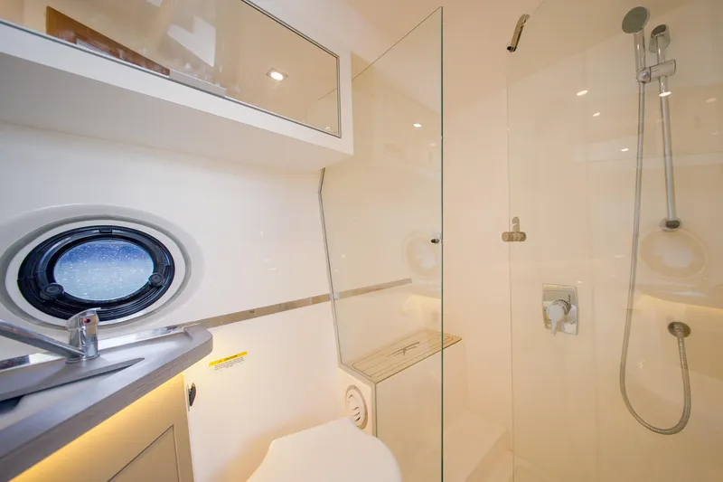  Yacht Photos Pics Luxurious bathroom in 2026 Granfort 370 GTX yacht with modern shower and porthole window.