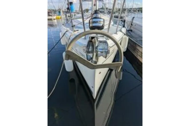 Dolce Vita Yacht Photos Pics 2004 Hunter 41 AC sailboat docked in marina, featuring steering wheel and deck view.