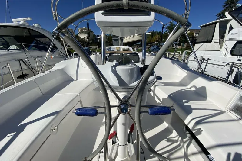 Dolce Vita Yacht Photos Pics Cockpit of 2004 Hunter 41 AC sailboat with steering wheel and navigation equipment.