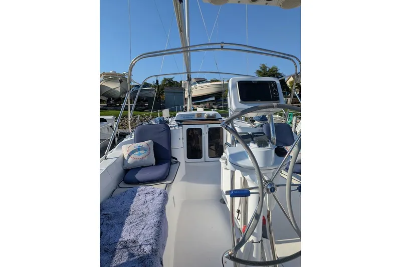Dolce Vita Yacht Photos Pics Cockpit of 2004 Hunter 41 AC sailboat with steering wheel and navigation equipment.