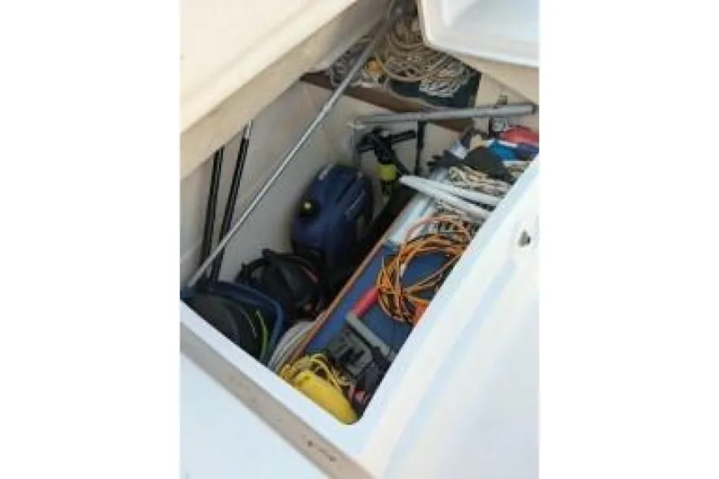 Dolce Vita Yacht Photos Pics Storage compartment on a 2004 Hunter 41 AC sailboat, filled with ropes and equipment.
