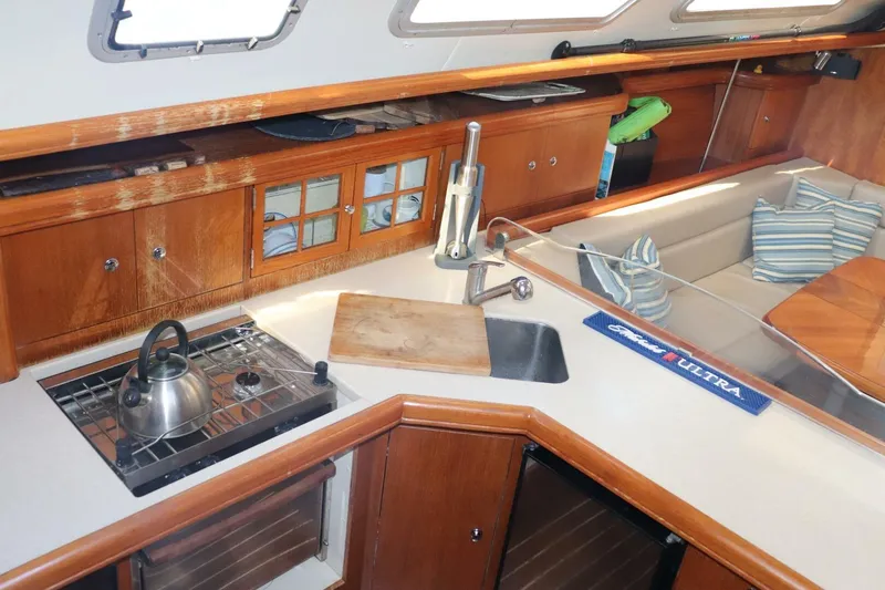 Dolce Vita Yacht Photos Pics 2004 Hunter 41 AC yacht interior with kitchen, sink, and seating area.