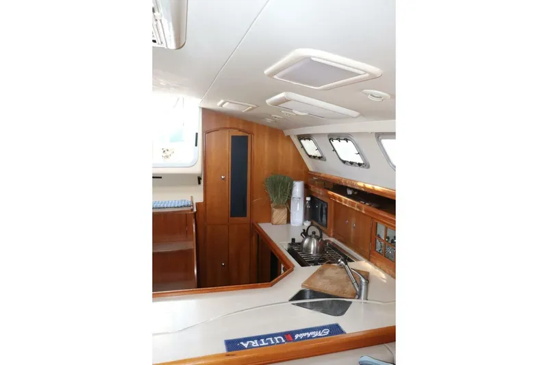 Dolce Vita Yacht Photos Pics Interior of 2004 Hunter 41 AC yacht kitchen with wooden cabinetry and modern appliances.