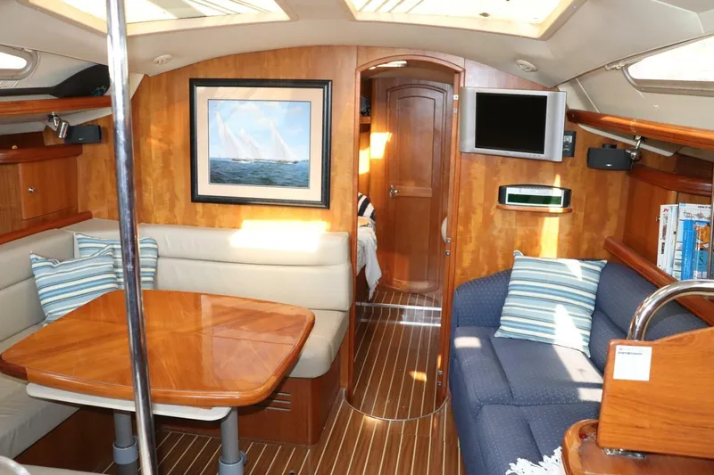 Dolce Vita Yacht Photos Pics Interior of 2004 Hunter 41 AC sailboat with cozy seating and wooden finishes.