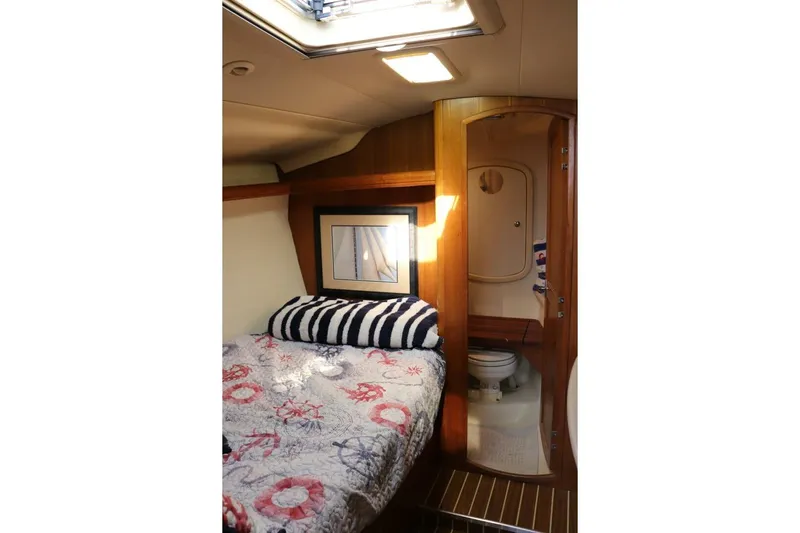 Dolce Vita Yacht Photos Pics Cozy cabin interior of 2004 Hunter 41 AC sailboat with bed and bathroom.