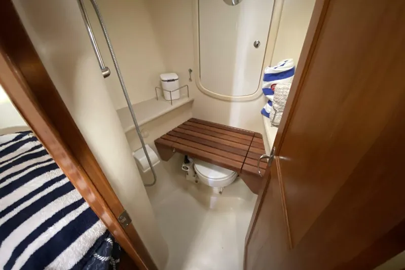Dolce Vita Yacht Photos Pics Compact bathroom in 2004 Hunter 41 AC yacht with shower and wooden bench.