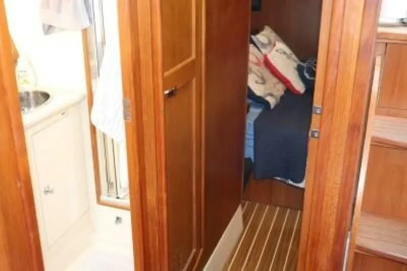 Dolce Vita Yacht Photos Pics Interior of 2004 Hunter 41 AC sailboat showing wooden cabinetry and cozy sleeping area.