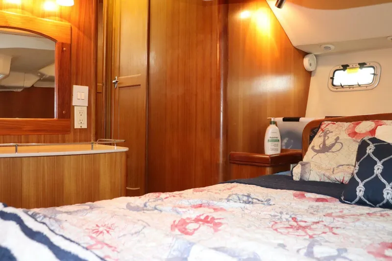 Dolce Vita Yacht Photos Pics Cozy cabin interior of 2004 Hunter 41 AC sailboat with nautical-themed bedding.